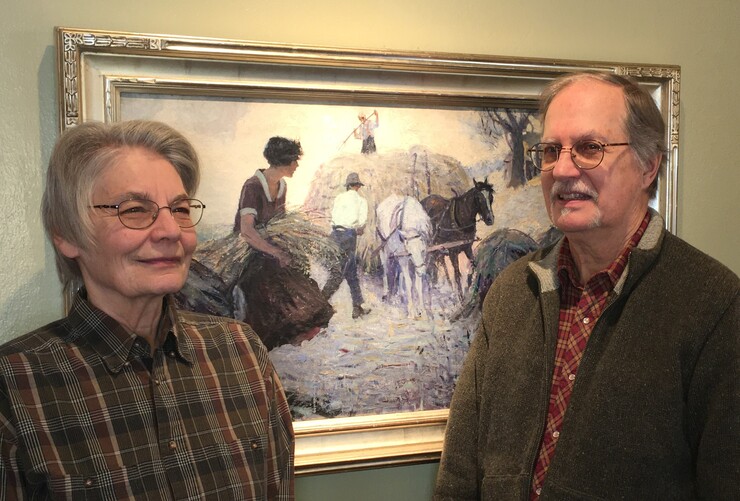 Carol and Mark Moseman of David City, Nebraska, with “Fighting Blood,” a painting by Frank L. Spradling (1885–1972).