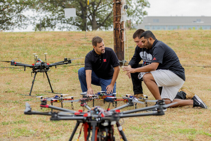 Justin Bradley, associate professor of computer science and engineering, discusses unmanned aerial vehicles with graduate students Daniel Rico and Chandima Fernando at the NIMBUS lab on Nebraska Innovation Campus on Oct. 6.