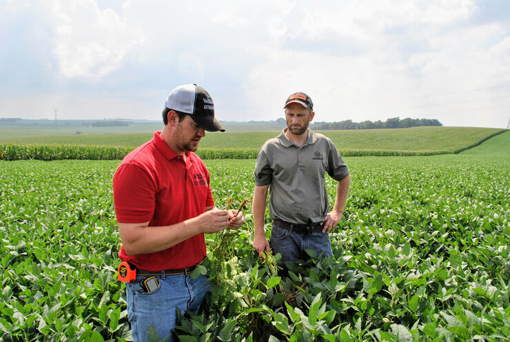 Nathan Mueller (left), Nebraska Extension educator, assesses an on-farm experiment with a producer participating in the Nebraska On-Farm Research Network.