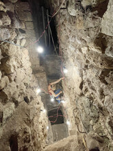 Heather Richards-Rissetto scales a ladder to go deeper into Tunnel 16.