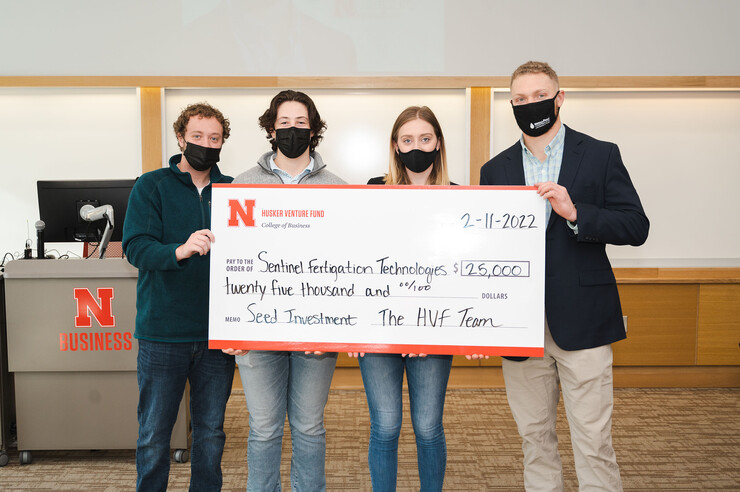 Members of the Husker Venture Fund awarded the first investment of $25,000 to Jackson Stansell, a biological systems engineering doctoral student at Nebraska. The HVF is a student-led venture capital fund that invests in Nebraska-owned early-stage startups. Pictured from left are students and managing directors of the fund Keith Nordling, Adam Folsom and Emily Kist, alongside Stansell.