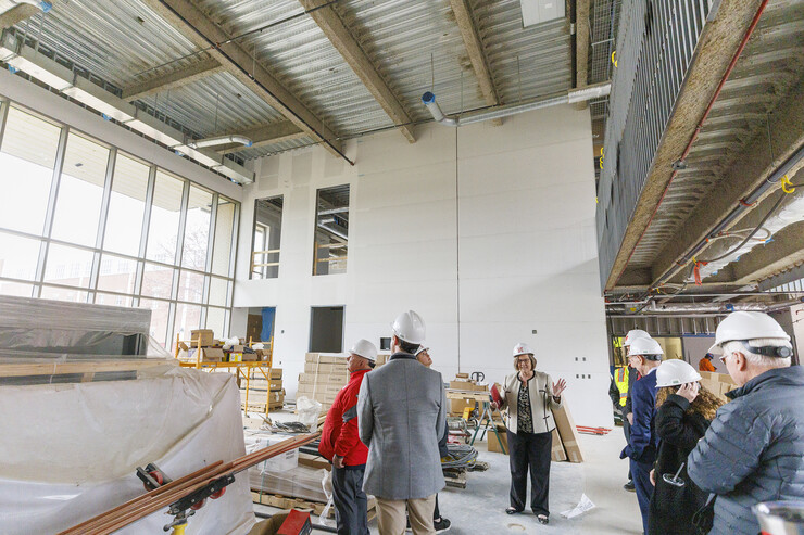 Sherri Jones, dean of education and human sciences, describes the open space called the “living room” under construction in Carolyn Pope Edwards Hall during a Board of Regents tour April 7.