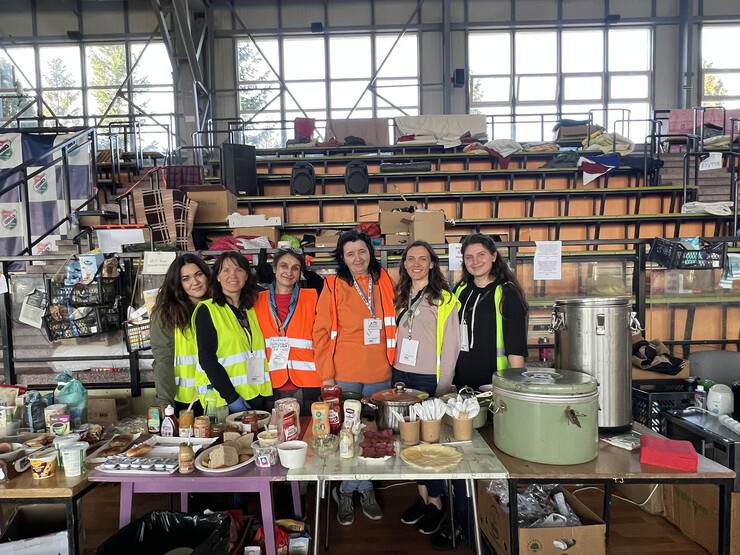 To ease refugees' nerves, volunteers made certain food was ready at all times. Nebraska's Tatyana Gulchuk (left) and other volunteers are shown here at a food station within an athletic facility that was converted into a refugee center.