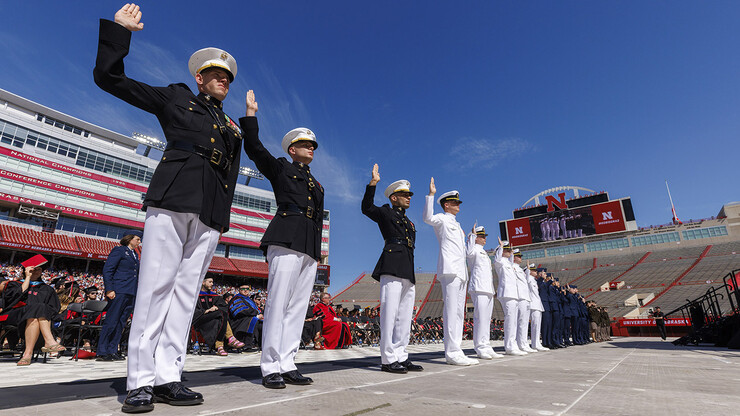 Air Force, Army and Naval ROTC members recite the oath of enlistment during the undergraduate commencement ceremony May 14 at Memorial Stadium.