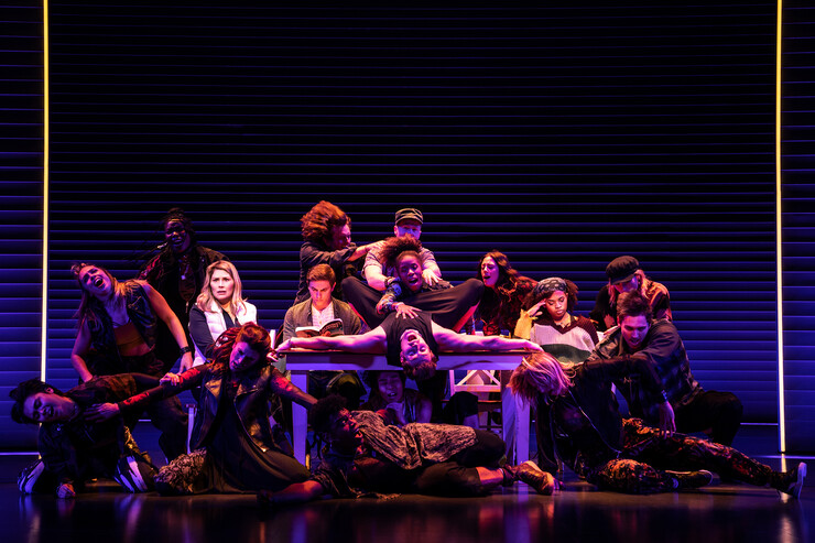 Group of performers contorted around table