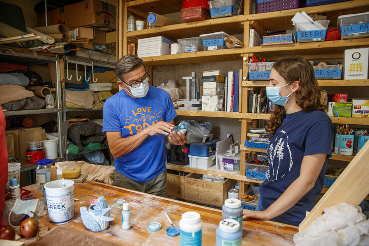 Eddie Dominguez, professor of art, works with UCARE student Kinga Aletto in August 2020. Aletto created a life-size clay model of the Javan blue-banded kingfisher.