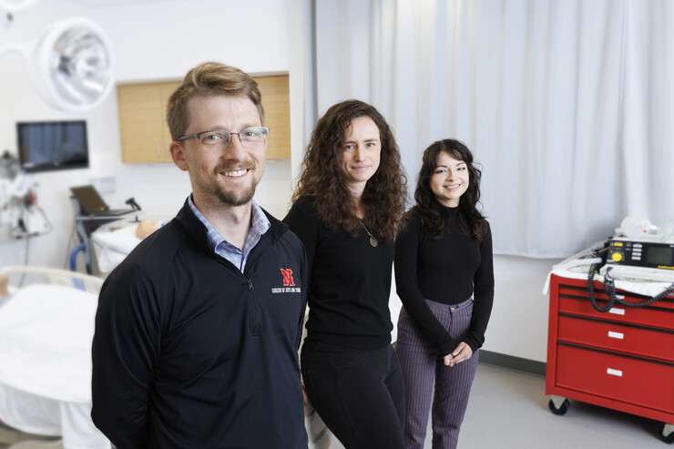 Husker researchers Arthur "Trey" Andrews, Tierney Lorenz and Sara Reyes pose in a patient room.