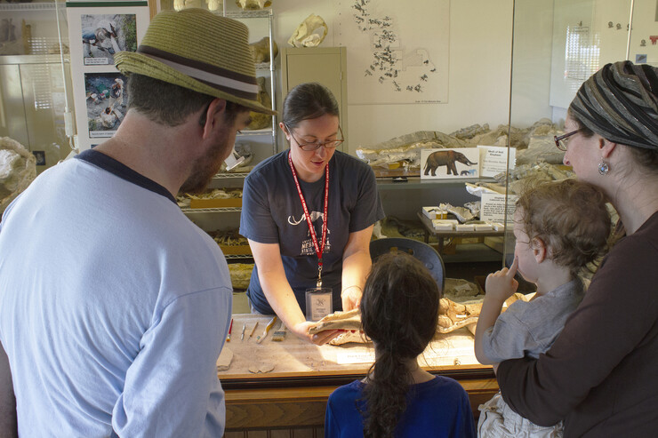 A family learns more about fossils from one of Ashfall Fossil Beds’ summer interns at the park’s Working Visible Lab.