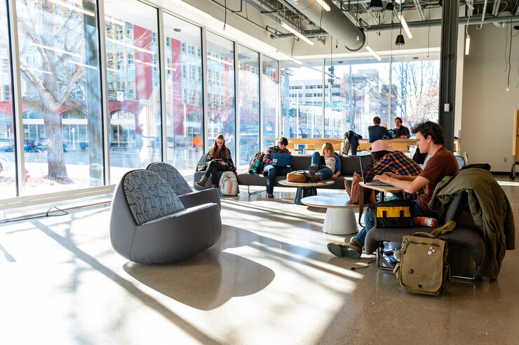 Students lounge in the Johnny Carson Center for Emerging Media Arts as sunlight streams through the windows