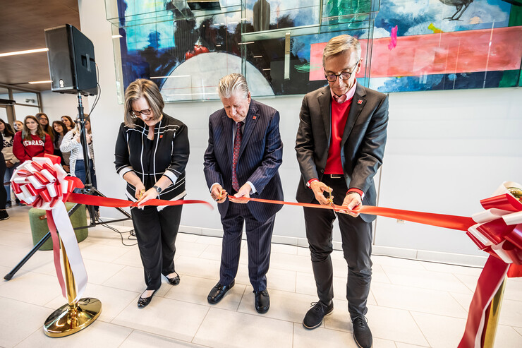 (From left) Sherri Jones, dean of the College of Education and Human Sciences; Rick Edwards, administrator and professor emeritus and Carolyn Pope Edwards’ widower; and Chancellor Ronnie Green cut the ribbon during the opening of Carolyn Pope Edwards Hall on Sept. 29.