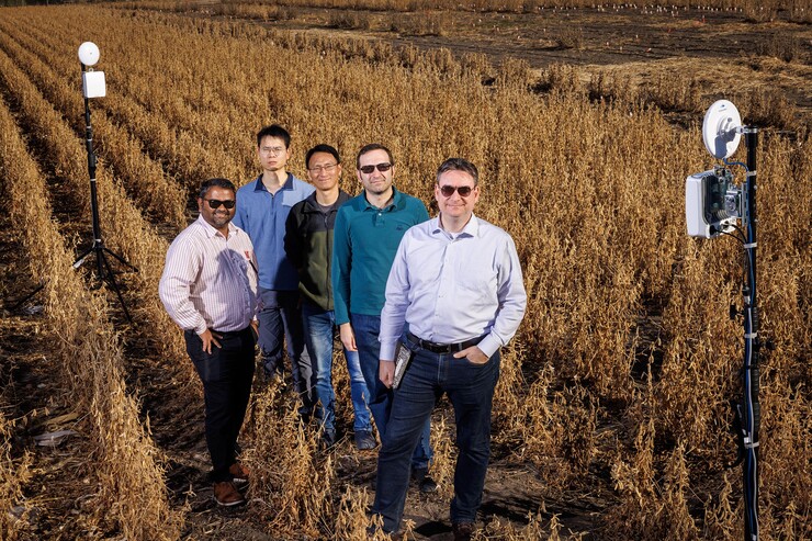 Members of the Field-Nets research team pose in a soybean field on East Campus with their millimeter wave radios with phased-array antennas. The researchers (from left) are Santosh Pitla, Qiang Liu, Yufeng Ge, Christos Argyropoulos and Mehmet Can Vuran.