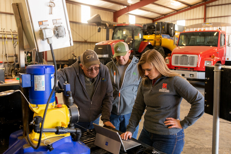 Taylor Cross (right), a graduate student in mechanized systems management, speaks with Nebraska ag producers Doug Jones (left) and Tony Jones about the sensor-based fertigation management technology that’s been shown to increase nitrogen-use efficiency and profitability in on-farm research.
