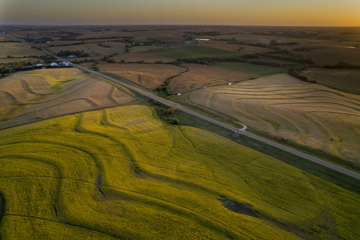 Corn and soybean fields create a patchwork of colors at sunset, bisected by Highway 43 in southeast Lancaster County. The market value of agricultural land in Nebraska increased 14% over the prior year, to an average of $3,835 per acre, according to a University of Nebraska–Lincoln report.