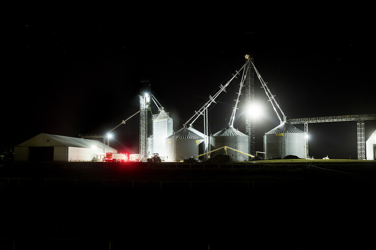 A farm site with four silos at night