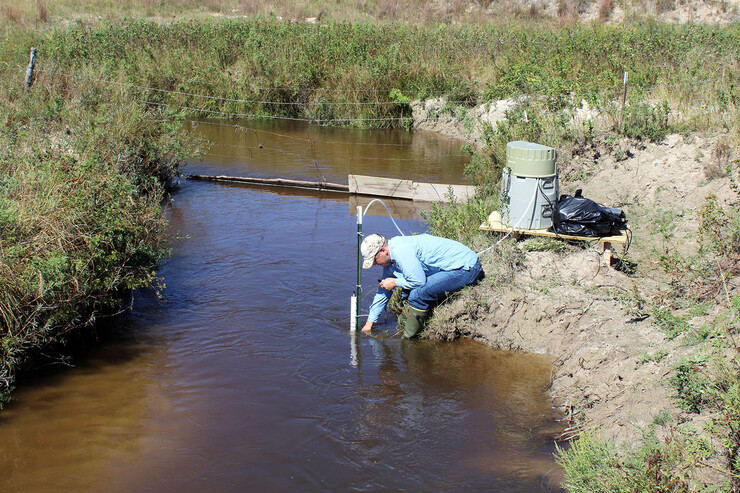 Troy Gilmore, associate professor of biological systems engineering, takes groundwater samples from the Loup River in Nebraska’s Sandhills in September 2018.
