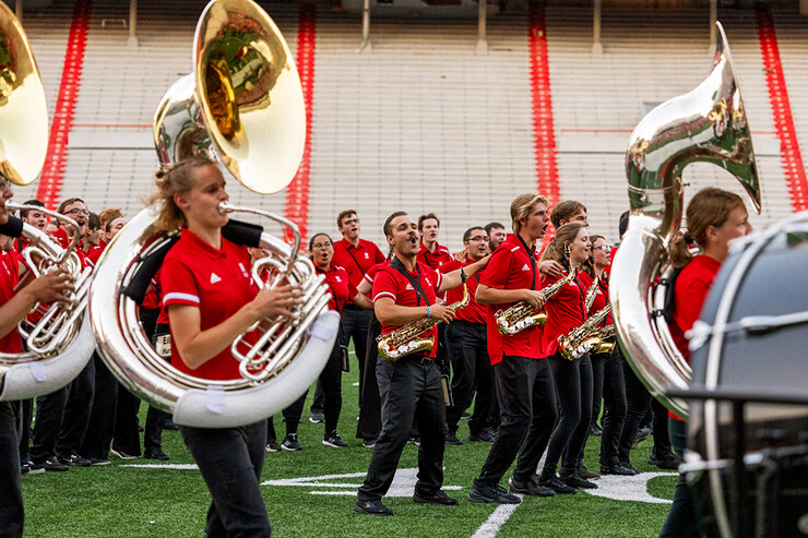 Some Cornhusker Marching Band members sing, while others play instruments during the band's annual exhibition Aug. 18 at Memorial Stadium.