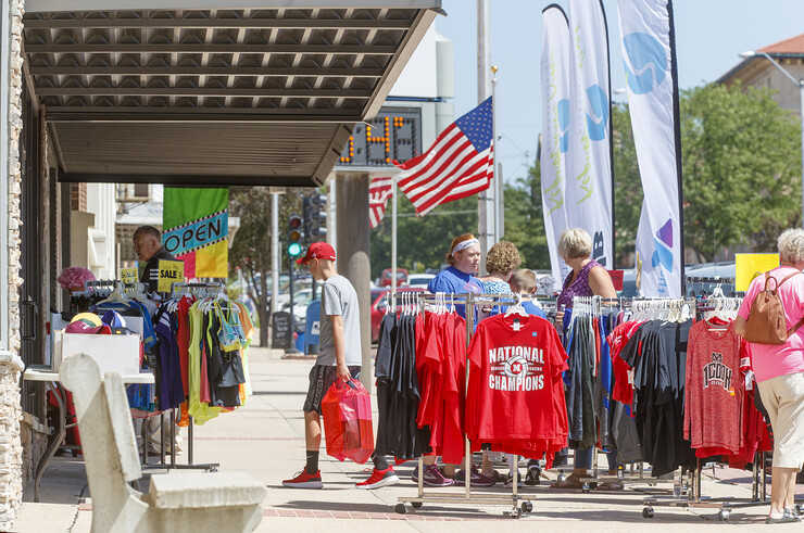 Shoppers look through T-shirts at a sidewalk sale in downtown McCook.
