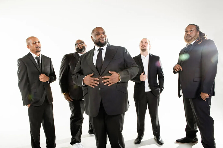 Five men — members of Big Wade and Black Swan Theory — stand in black suits against a white background.