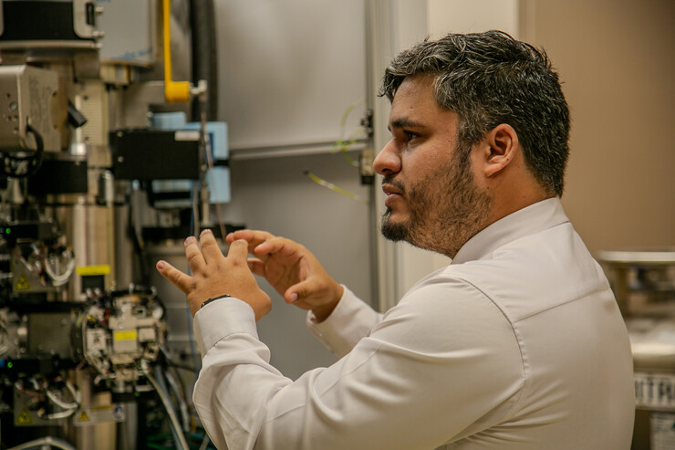 Eduardo Romero Camacho gestures with his hands as he gives a laboratory tour.