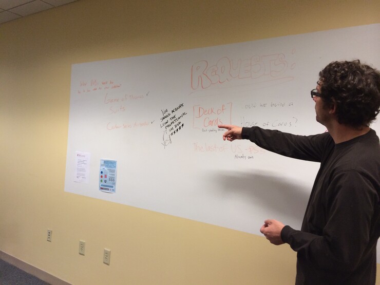 Richard Graham looks at the white board where library users make suggestions for new content. 