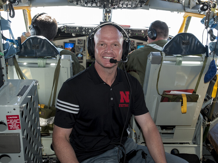 Matt Davison of Husker Athletics poses in the cockpit of a KC-135R Stratotanker during the civic leader flight over Nebraska.