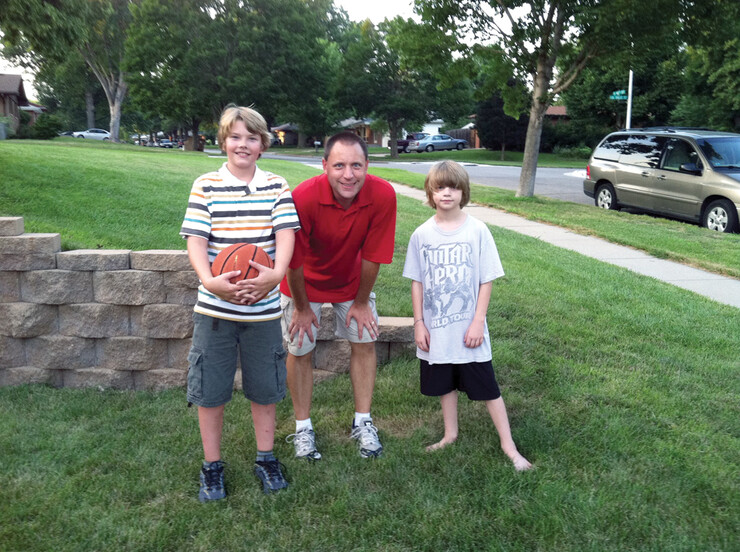Brian Reetz with Peter (left) and Nick, two children he helped grant wishes to through Make-A-Wish Nebraska.