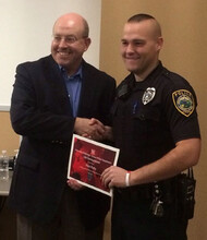 Chief Owen Yardley (left) congratulates Officer Alex Kelly, who received a UNLPD Lifesaving award.