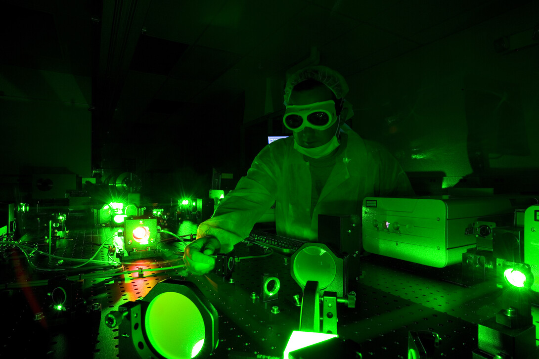 A technician adjusts the Diocles Laser in UNL's Extreme Light Laboratory. The lab is led by Donald Umstadter, one of four UNL researchers featured in the first report from the University of Nebraska's National Strategic Research Institute.