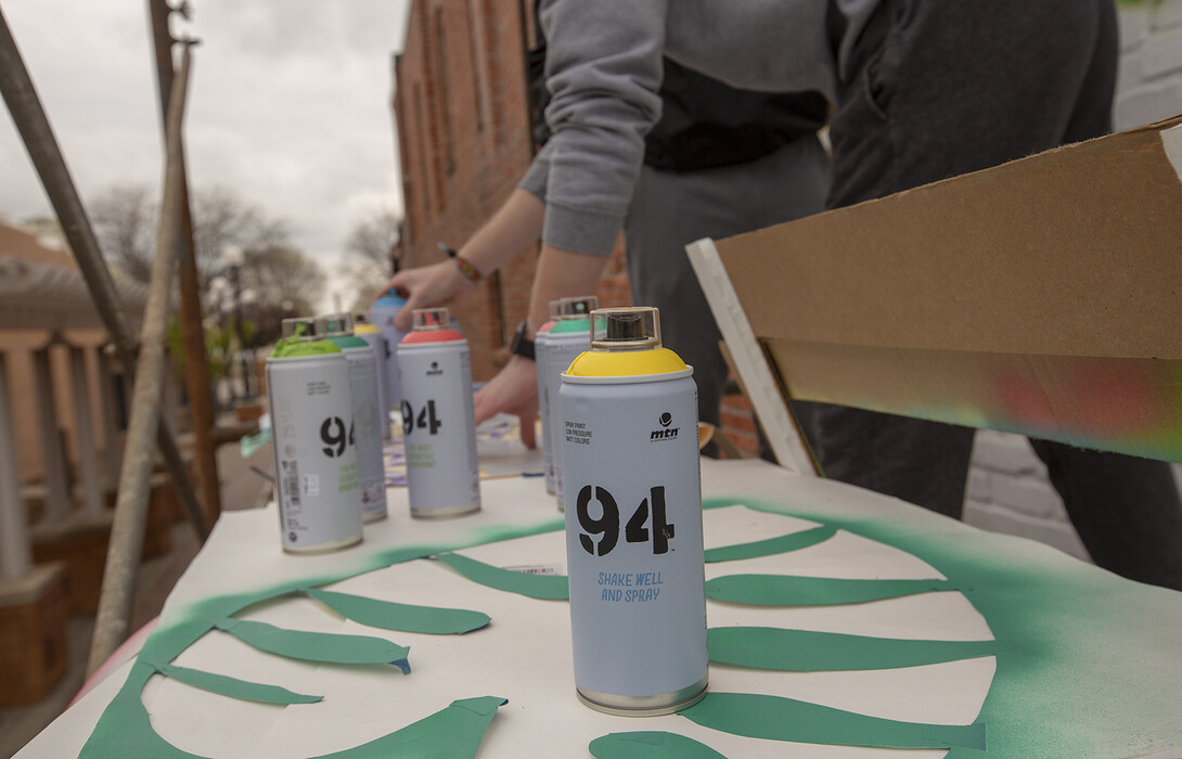 To create the mural, students used spray paint (the same kind used by many street artists) and hand-cut stencils. The patterns repeated multiple times in the 20-foot by 20-foot square mural.