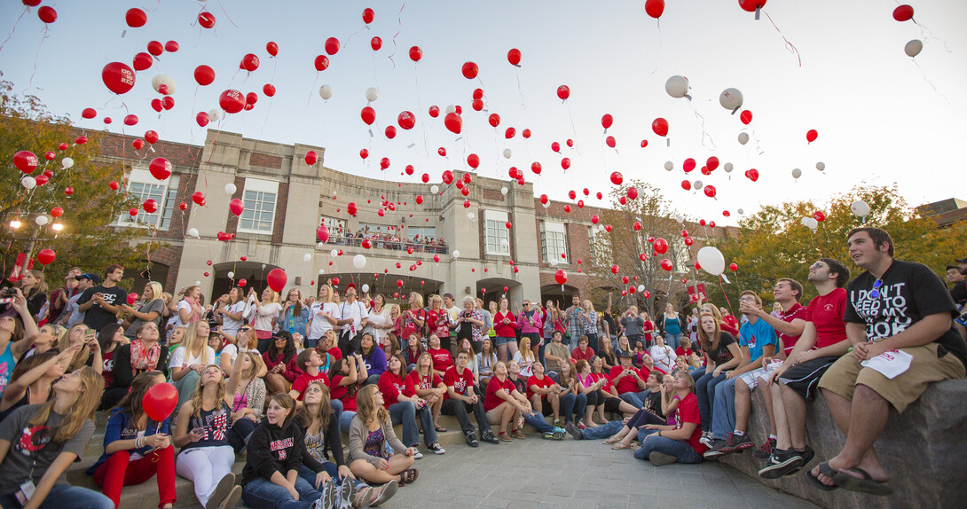 Husker fans release balloons during the 2012 UNL Homecoming pep rally outside the Nebraska Union.