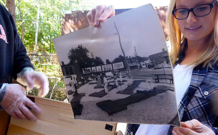 A student examines a photo during a UNL History Harvest event in Omaha. The third annual History Harvest is March 15.