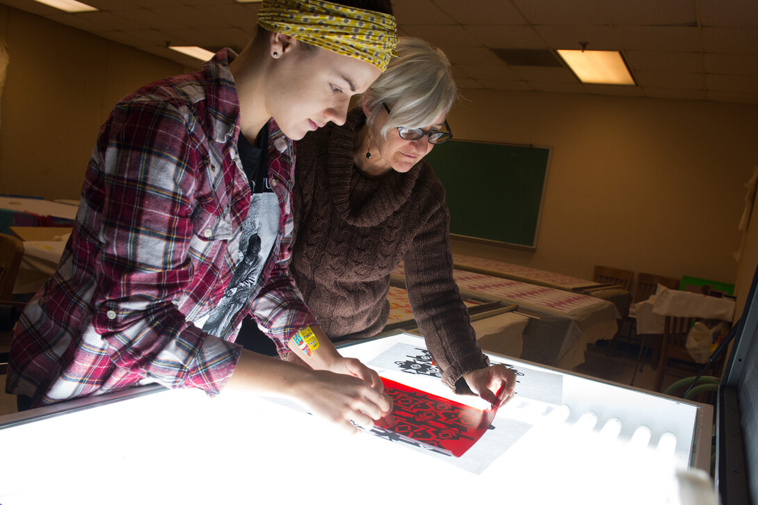 Wendy Weiss (right) works with a student in a Textiles, Merchandising and Fashion Design studio. Weiss received a second Fulbright that will allow her to expand research into the ikat weaving method.