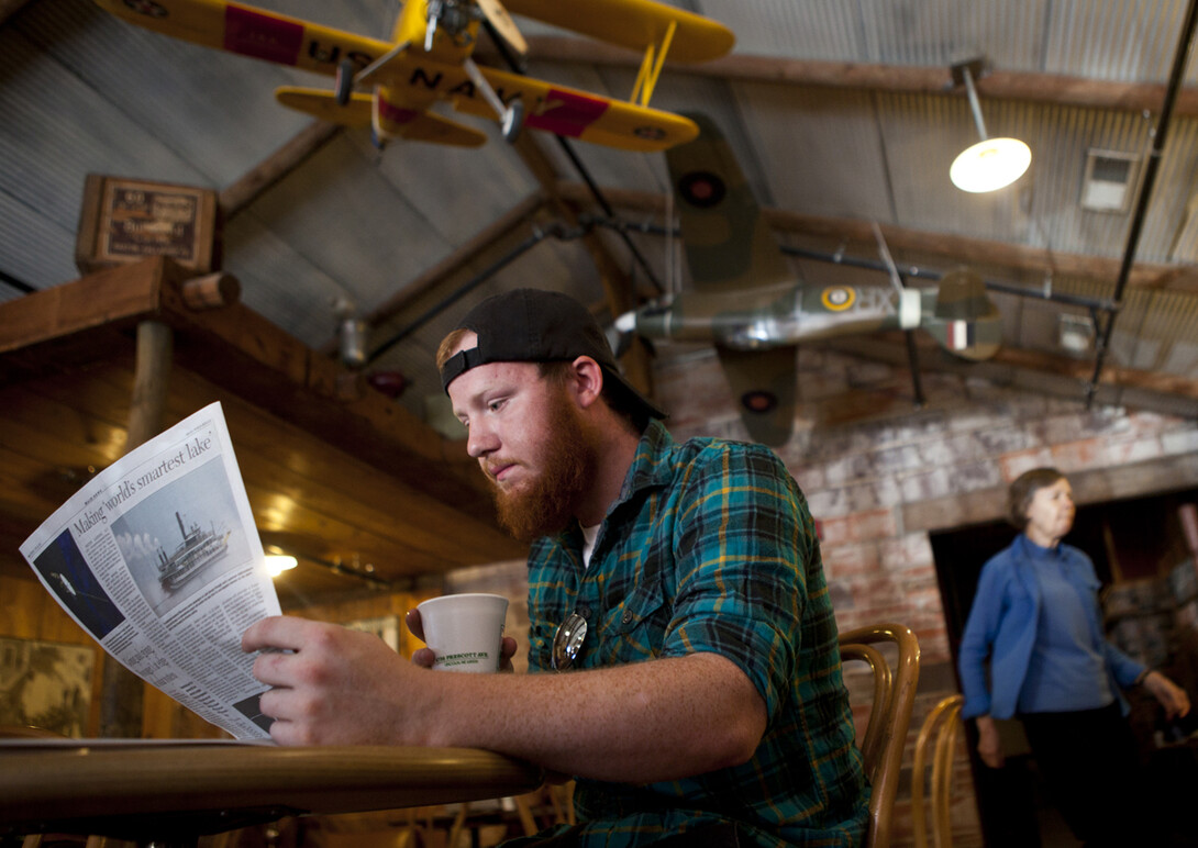 A customer enjoys a cup of coffee at the Grind Coffee Shop in Lincoln's Haymarket. A survey completed in March showed Nebraska businesses remain positive about Nebraska's economy.