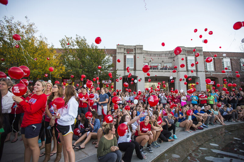 Husker fans release balloons during the Oct. 4 UNL Homecoming pep rally on the Nebraska Union Plaza.