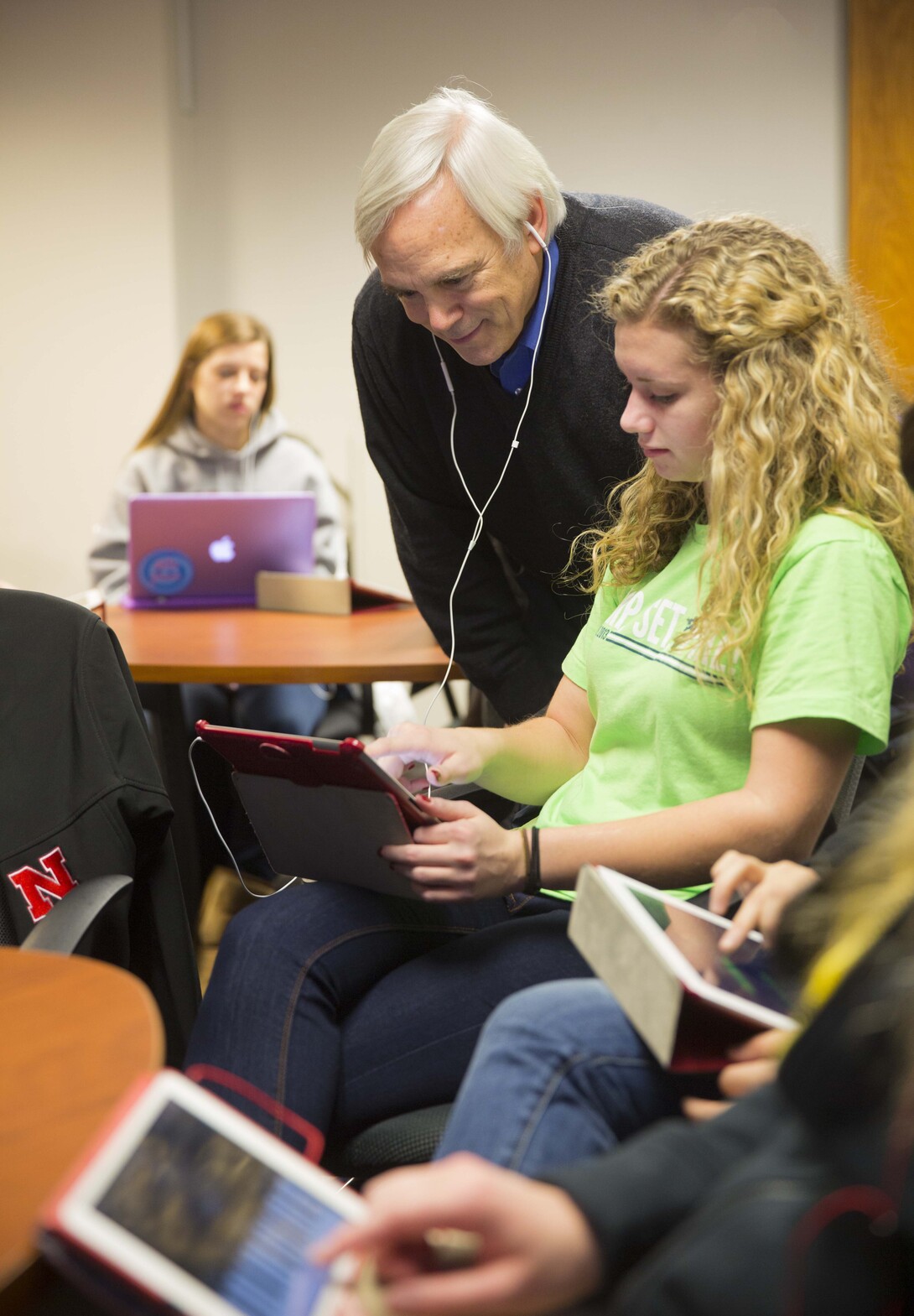 Brian Moore, associate professor of music, listens in on Ashley Dyer's work for an honors seminar. Moore uses iPads extensively in his classes. 