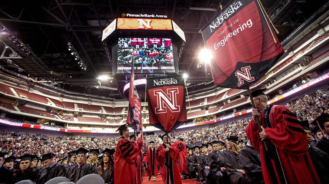 College banners stream onto floor during UNL commencement exercises in December 2013.