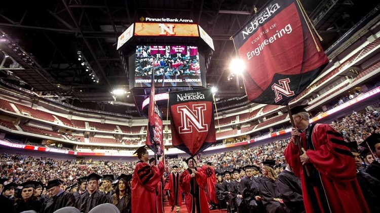 Member of UNL's commencement marshal corps carry college gonfalons into Pinnacle Bank Arena at the start of commencement exercises in Pinnacle Bank Arena. The Nebraska Alumni Association hosts a two-day celebration for December 2015 graduates, Dec. 1-2 at the Wick Alumni Center.