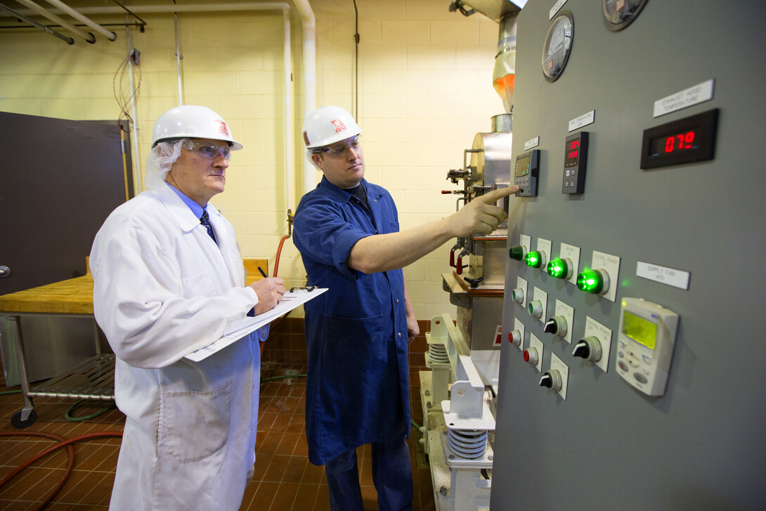 Biological Systems Engineering Professor Curtis Weller and Steve Weier, FPC Pilot Plant manager, look over equipment.