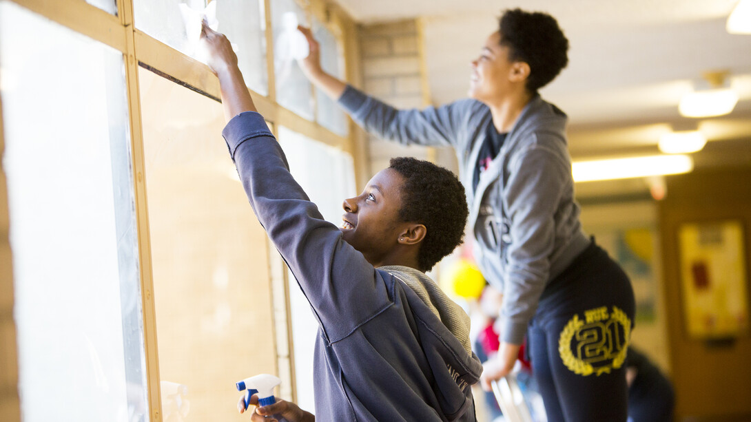 Nebraska students clean windows as part of a previous Big Event activity organized through ASUN. The 2018 Big Event is April 7 and will include more than 3,000 volunteers working across Lincoln.