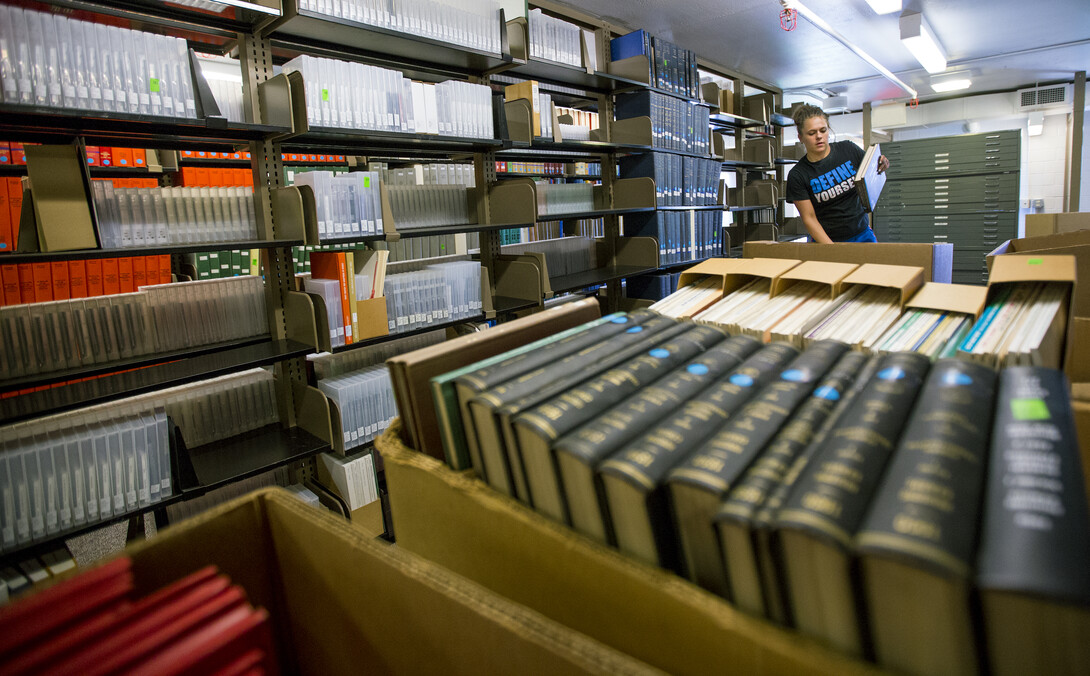 Danielle McGinnis with VonRentzell Movers packs books in the 3rd floor stacks of Love Library South as part of the Learning Commons Project. The shifting of books and journals within Love Library is heralding the start of UNL’s Learning Commons project.