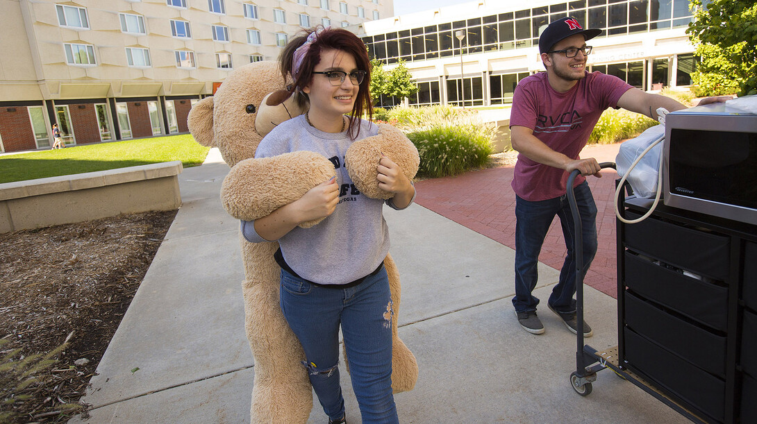 Hanging onto her stuffed bear, Sarah Loeffler, moved into UNL's Harper Hall with the help from her older brother, James, on Aug. 20. Students will continue to move into UNL's residence halls throughout the weekend, leading up to the start of fall semester on Aug. 24.