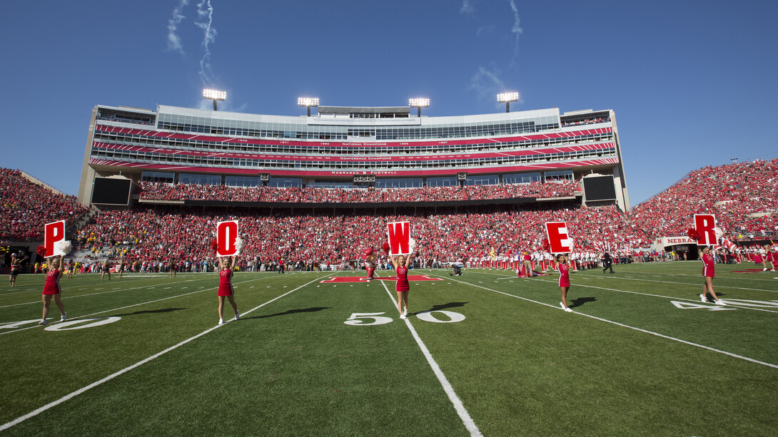 Nebraska cheerleaders take the field for a Husker Power cheer prior to the 2015 homecoming game in Memorial Stadium. Homecoming week activities this year culminate in the Huskers' game with IIllinois on Oct. 1.
