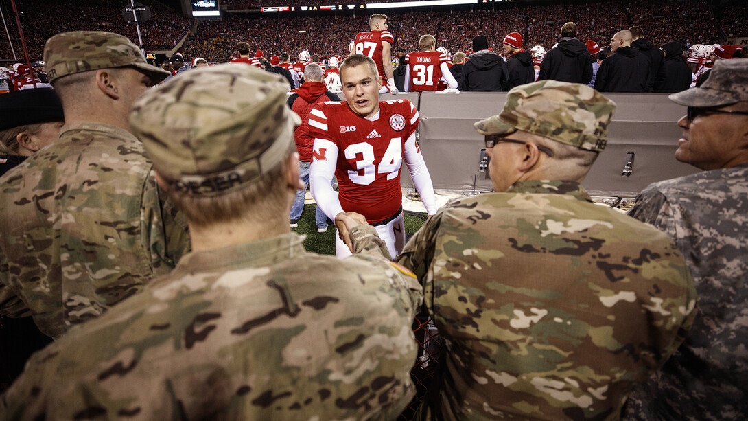 Husker kicker Drew Brown shakes hands with veterans during the 2016 football game against Minnesota in Memorial Stadium.