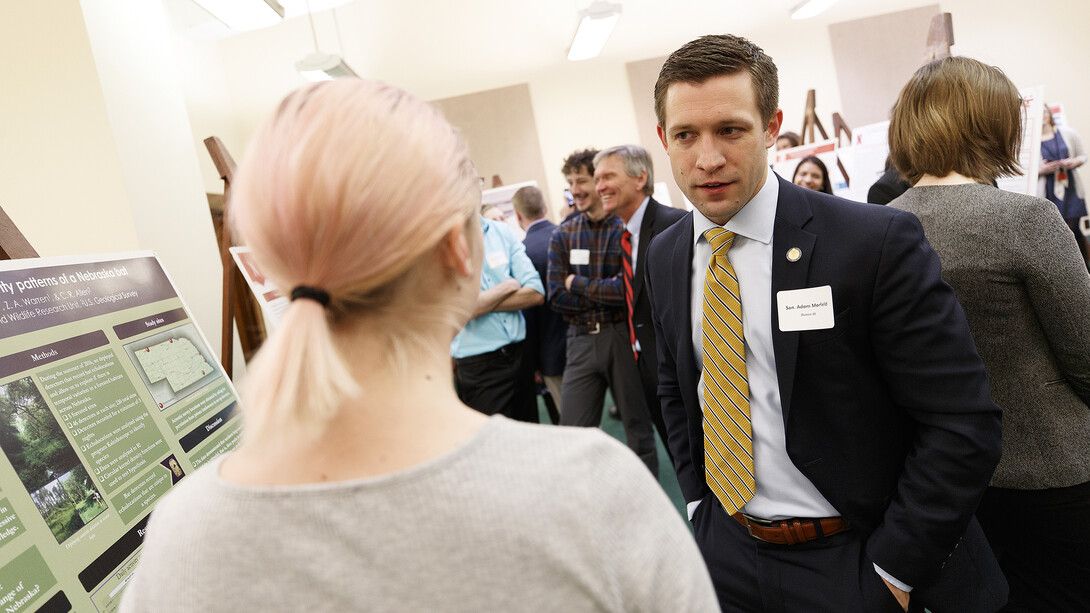 Nebraska Sen. Adam Morfeld talks about a research project with an undergraduate scientist during a 2017 Spring Research Fair event.