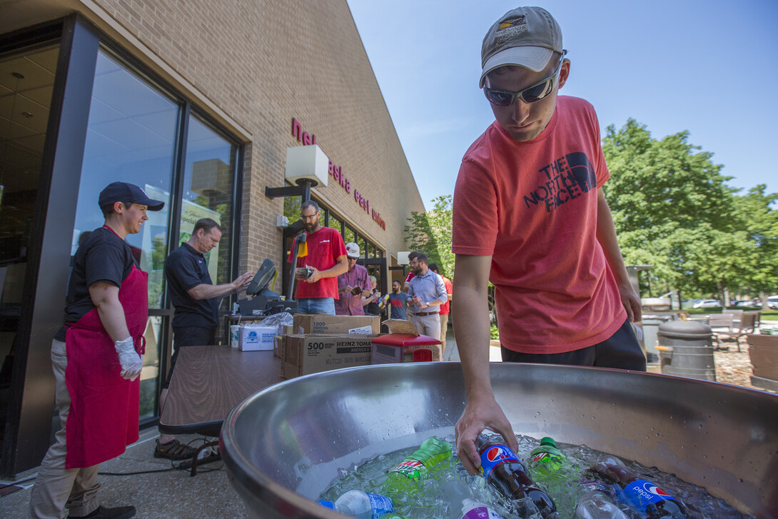 Nick Garst, a graduate student in agronomy and horticulture, searches for a drink during an East Union Café and Grill summer grill out. Meals, which include a main dish, side and drink, are about $6.