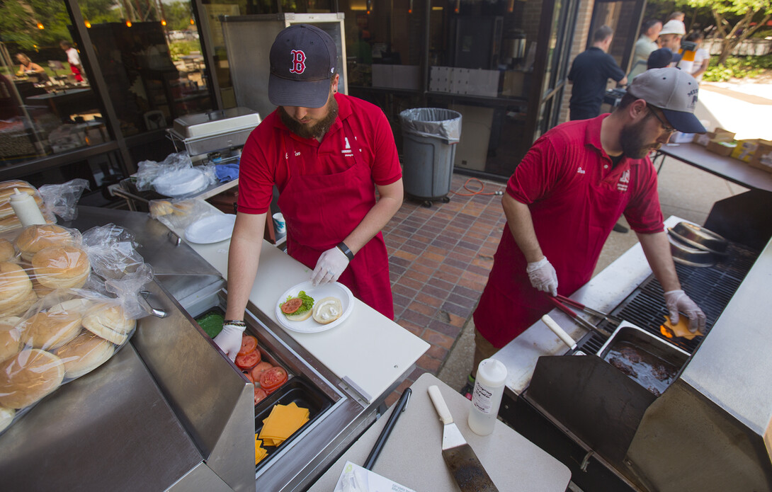 .Housing employees (from left) Clayton Boden and Dan Bell work the grill line outside the East Union.