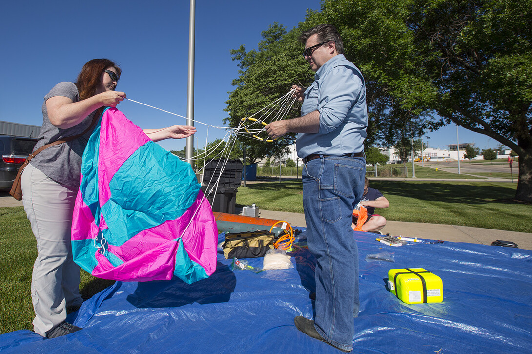 Kendra and Michael Sibbernsen prepare a parachute for a high-altitude balloon release. The Sibbernsens are co-leaders of NASA Nebraska's High Altitude Balloon Program.