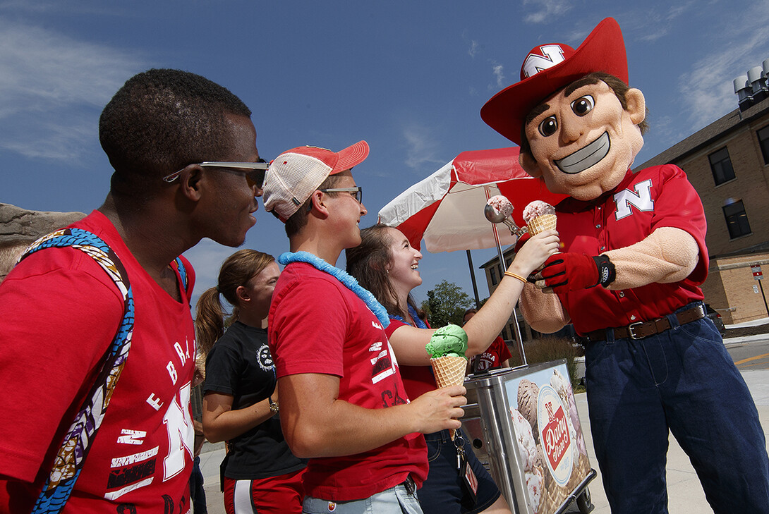 Herbie Husker dishes out ice cream from the Dairy Store's mobile cart. The Dairy Store goes on the road to the Nebraska State Fair every year, serving about 2 tons of ice cream to visitors.