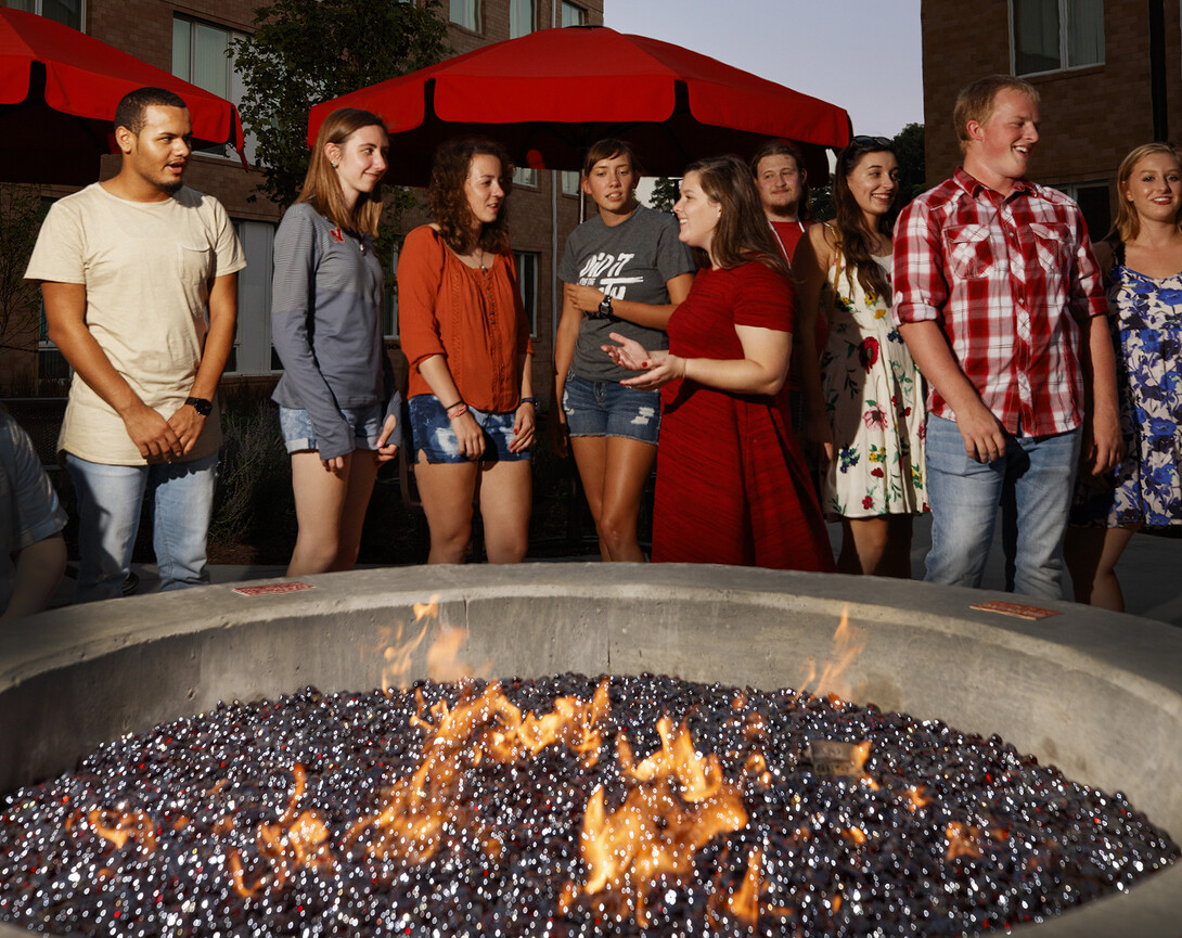 Students gather around the fire pit in the courtyard of Nebraska's Massengale Residential Center.