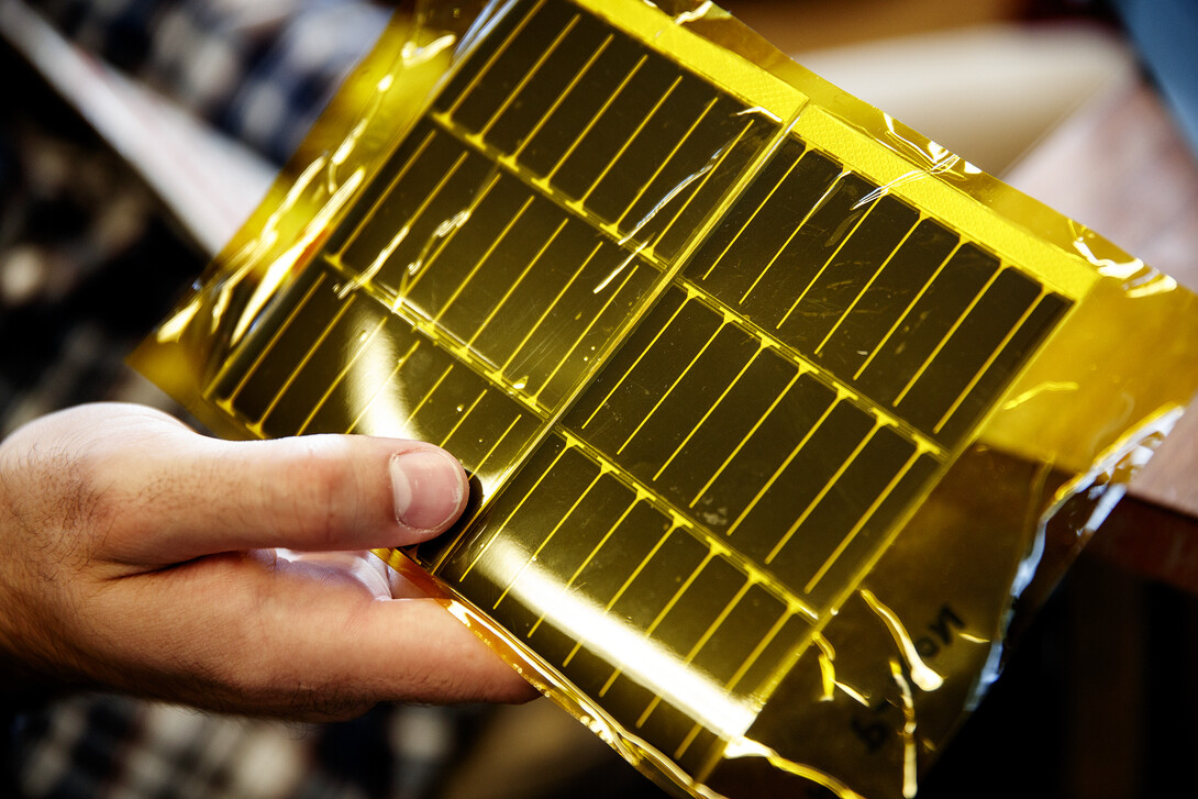 The student’s carbon fiber boom design includes flexible solar panels. The panels, shown here, are encased in yellow mylar. A mock panel will be used for the upcoming NASA vibration test.